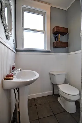a bathroom with a sink a toilet and a window
