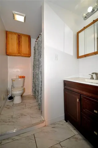 a view of a livingroom with wooden floor and a ceiling fan