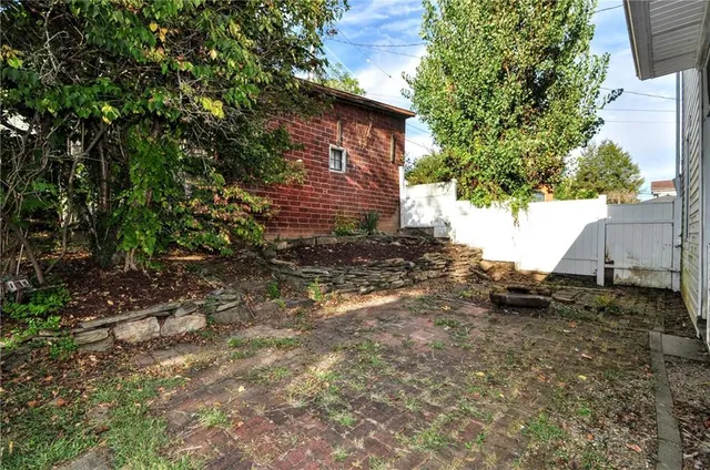 a view of a backyard with large trees