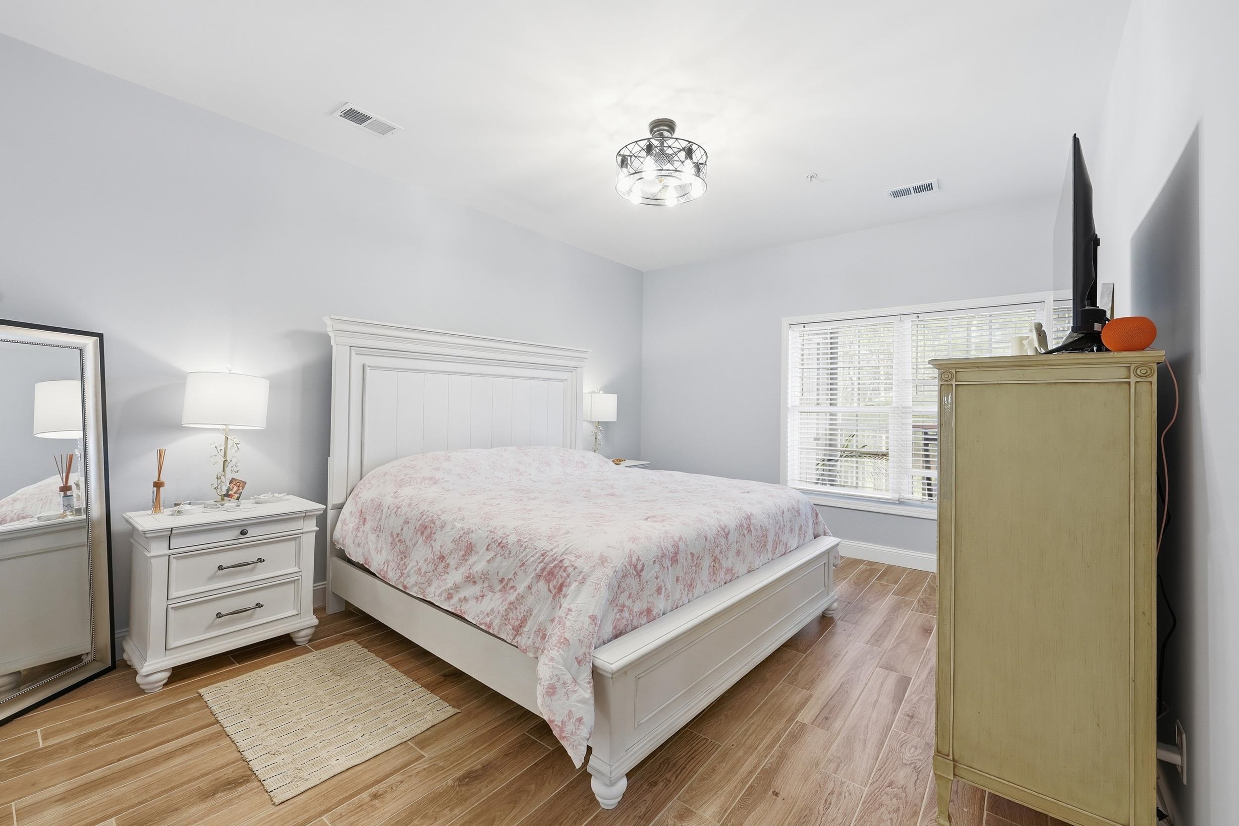5810 Longwood Drive, Unit 303 Murrells Inlet, SC 29576 - Photo 11 of 27 Bedroom with light wood-style flooring and baseboards
