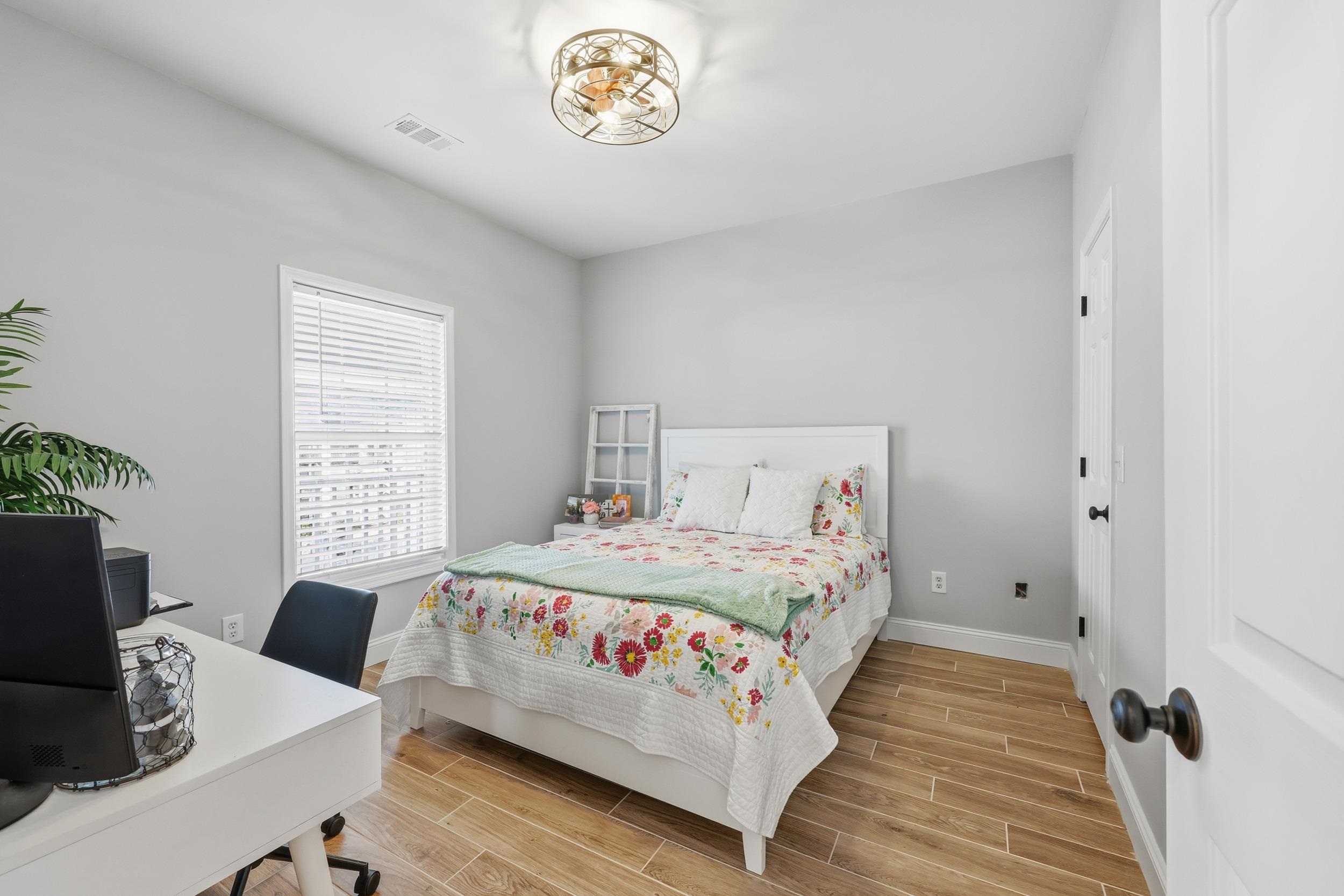 5810 Longwood Drive, Unit 303 Murrells Inlet, SC 29576 - Photo 9 of 27 Bedroom featuring wood tiled floors and an office area