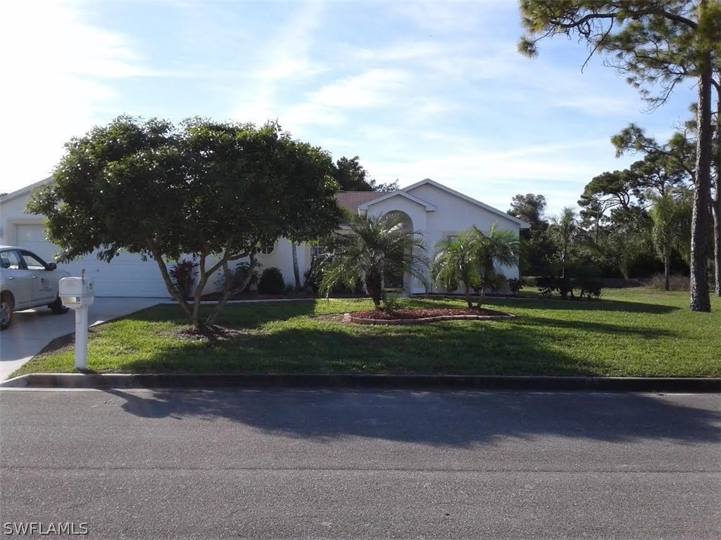 210 Roat Street Lehigh Acres, FL 33936 - Photo 1 of 9 a view of a park with large trees
