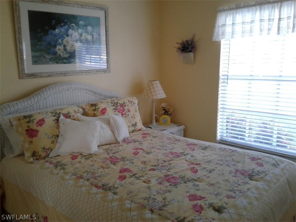 210 Roat Street Lehigh Acres, FL 33936 - Photo 3 of 9 a bedroom with a bed and a window