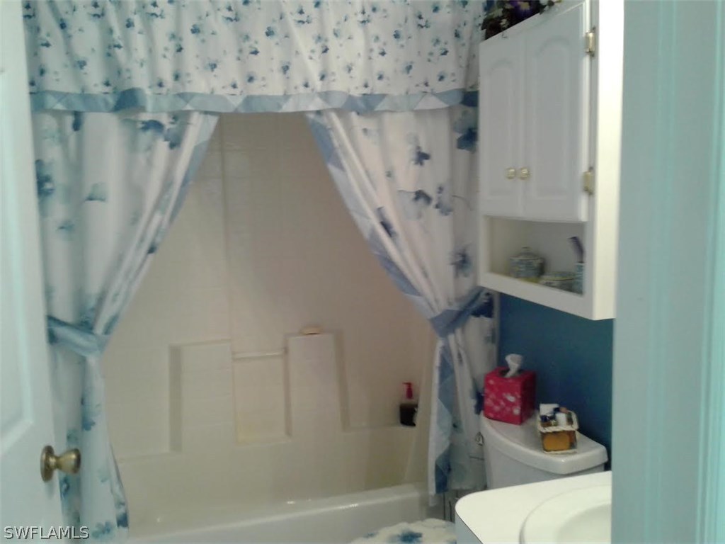 210 Roat Street Lehigh Acres, FL 33936 - Photo 4 of 9 a bathroom with a shower