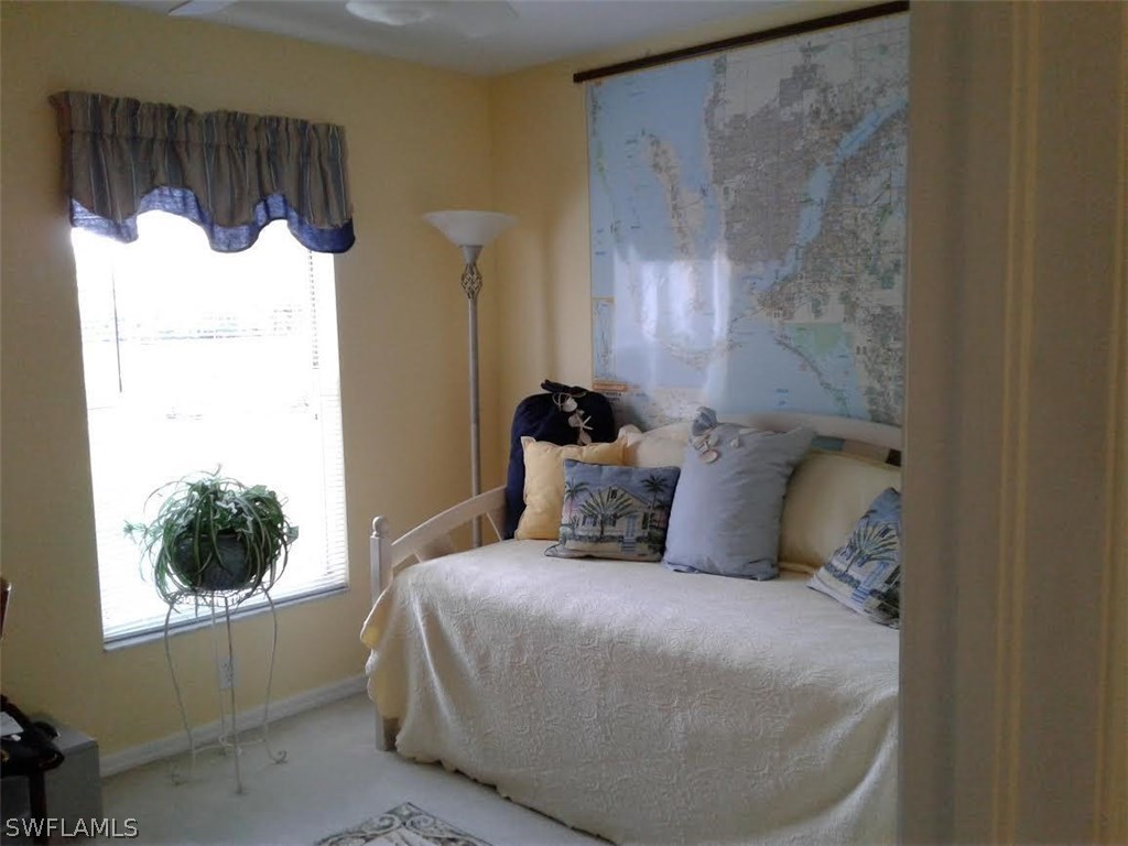 210 Roat Street Lehigh Acres, FL 33936 - Photo 5 of 9 a bedroom with a bed and a window