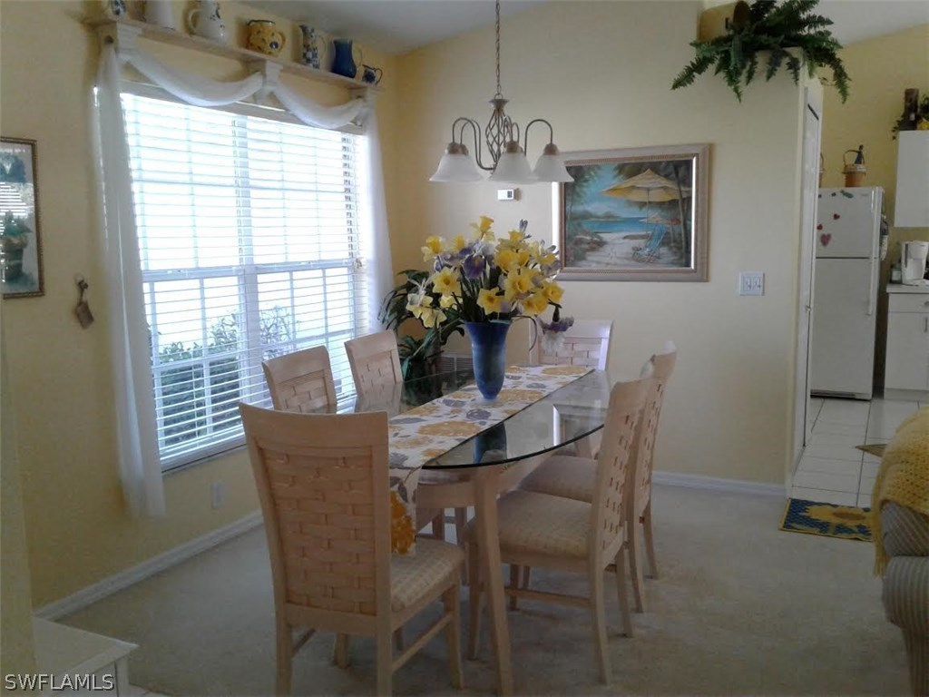 210 Roat Street Lehigh Acres, FL 33936 - Photo 6 of 9 a dining room with furniture and window