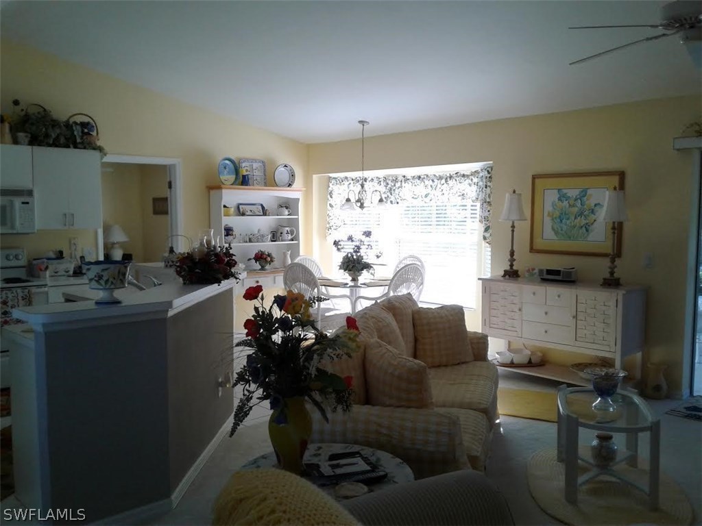 210 Roat Street Lehigh Acres, FL 33936 - Photo 8 of 9 a living room with furniture and a large window