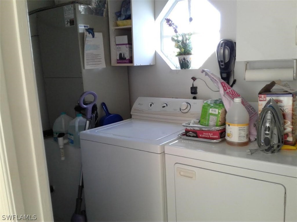 210 Roat Street Lehigh Acres, FL 33936 - Photo 9 of 9 a utility room with dryer and washer