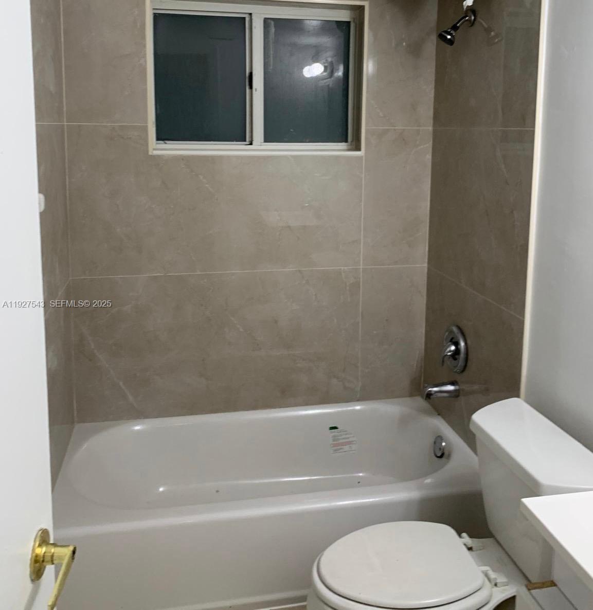 Park Place at Pompano Pompano Beach, FL 33060 - Photo 4 of 7 a white toilet and tub sitting next to a bathroom sink