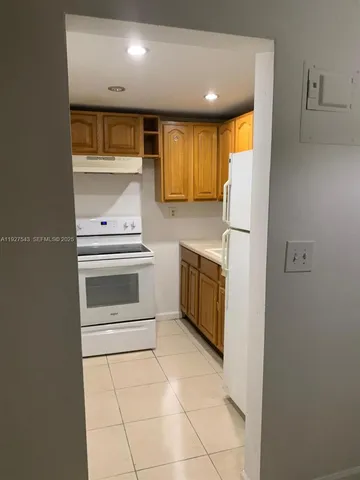 a kitchen with a stove top oven and cabinets