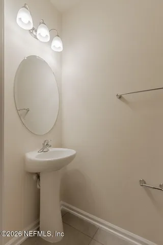 a bathroom with a sink mirror and toilet