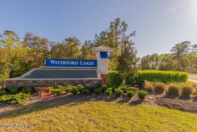 a sign that is sitting in front of a house
