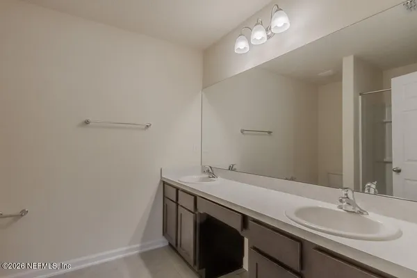 a bathroom with a glass shower door