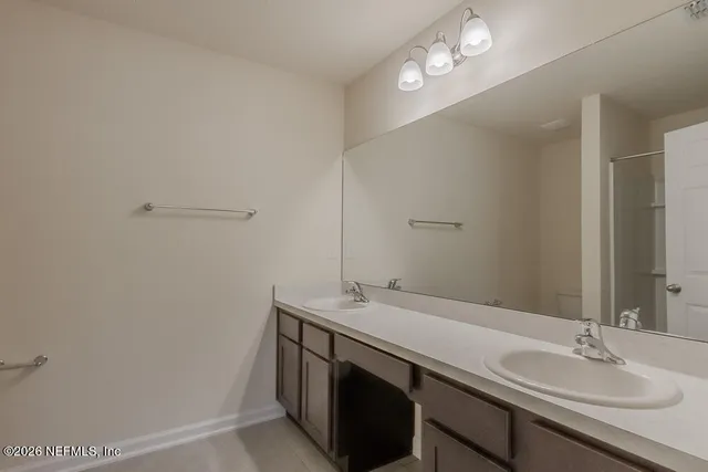 a bathroom with a glass shower door