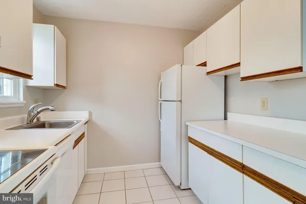 a kitchen with a sink and a refrigerator