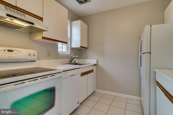 a kitchen with stainless steel appliances a sink and a refrigerator