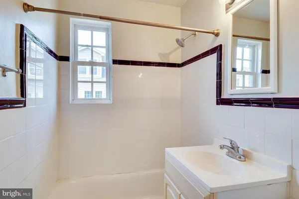 a bathroom with a sink a mirror and a bathtub