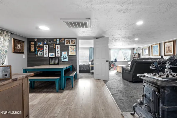 a living room with furniture a wooden floor and a piano