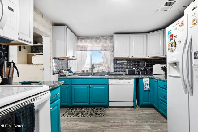 a kitchen with stainless steel appliances granite countertop a refrigerator sink and cabinets