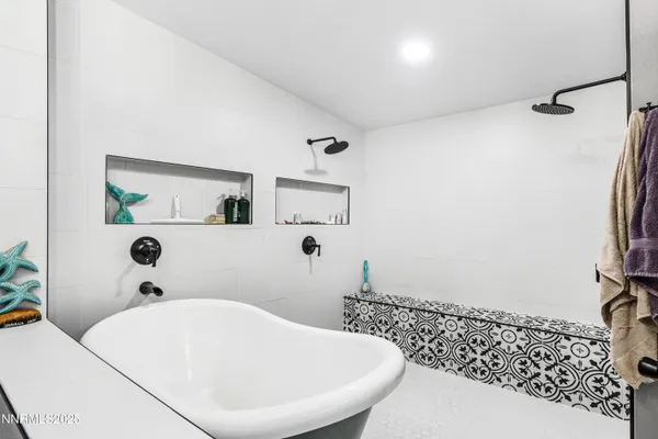 a bathroom with a bathtub and shower