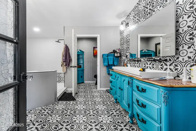 a bathroom with a double vanity sink and a mirror