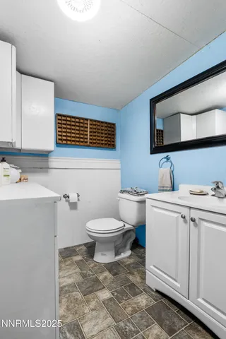 a bathroom with a sink toilet and vanity