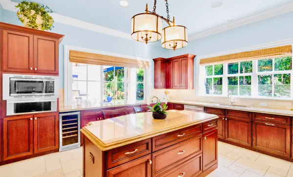 a kitchen with stainless steel appliances granite countertop a stove a sink and a microwave