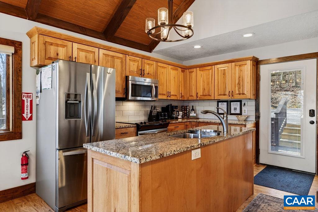 96 Squirrel Tree Lane Roseland, VA 22967 - Photo 13 of 46 a kitchen with stainless steel appliances granite countertop a refrigerator a oven a sink with wooden cabinets and wooden floor
