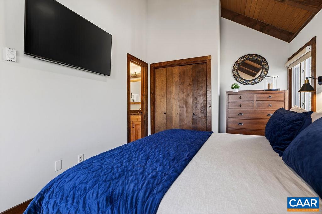 96 Squirrel Tree Lane Roseland, VA 22967 - Photo 23 of 46 a bedroom with a bed and a flat screen tv