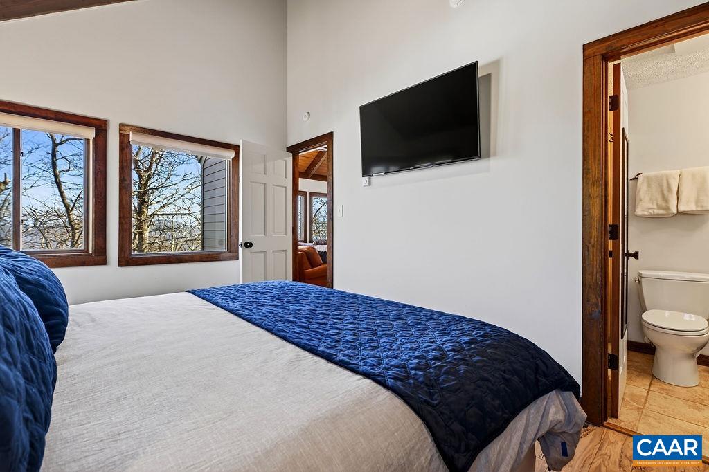 96 Squirrel Tree Lane Roseland, VA 22967 - Photo 25 of 46 a bedroom with a bed and a flat screen tv