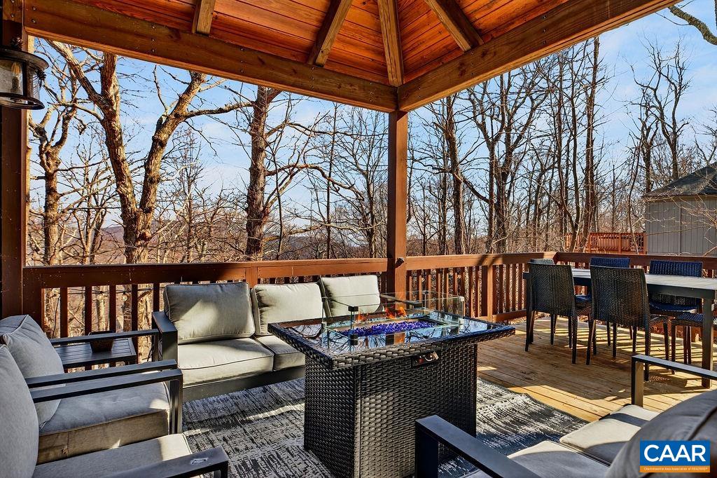 96 Squirrel Tree Lane Roseland, VA 22967 - Photo 32 of 46 a roof deck with couches and wooden fence