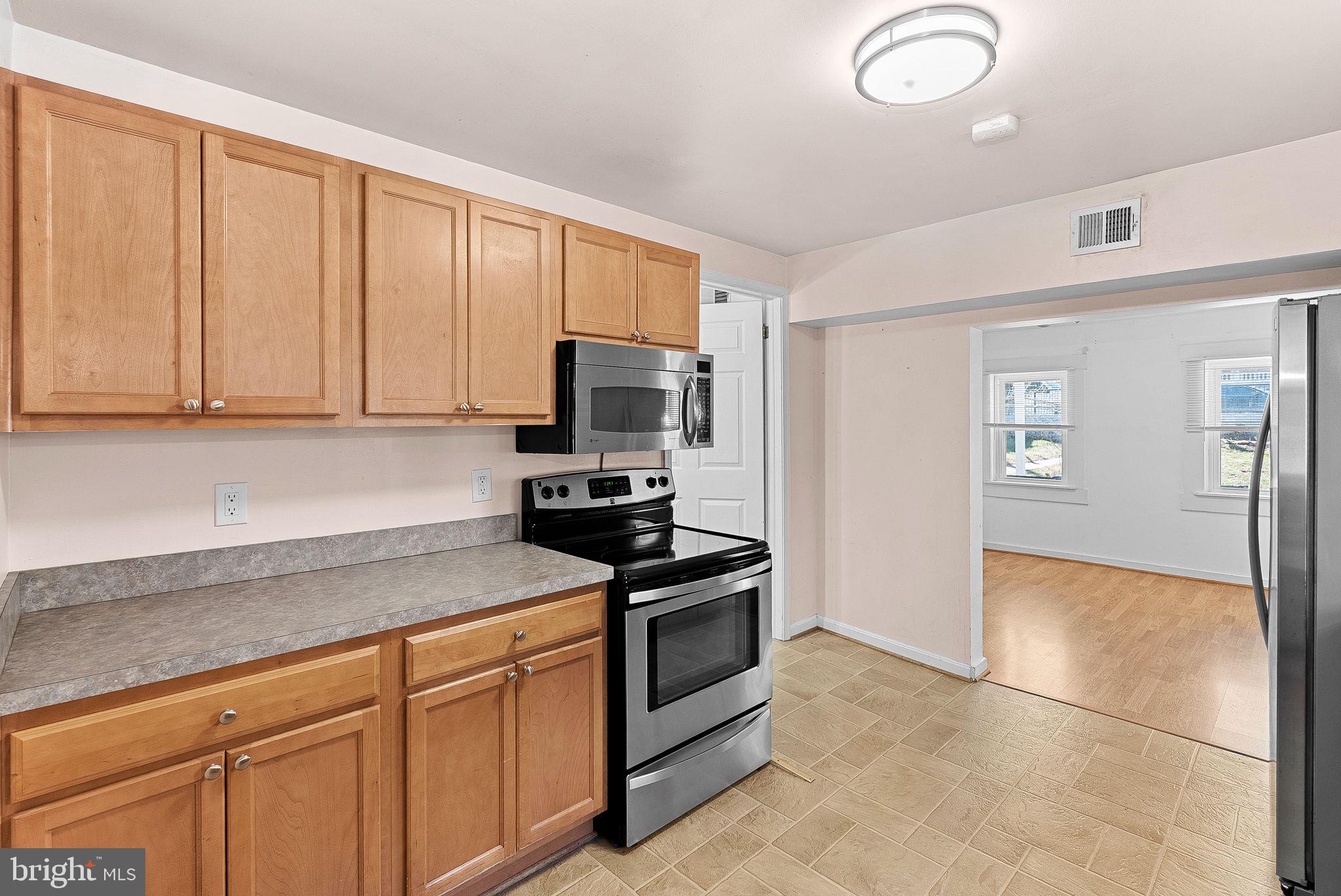 31 Main Street Round Hill, VA 20141 - Photo 11 of 35 a kitchen with granite countertop a refrigerator stove and microwave