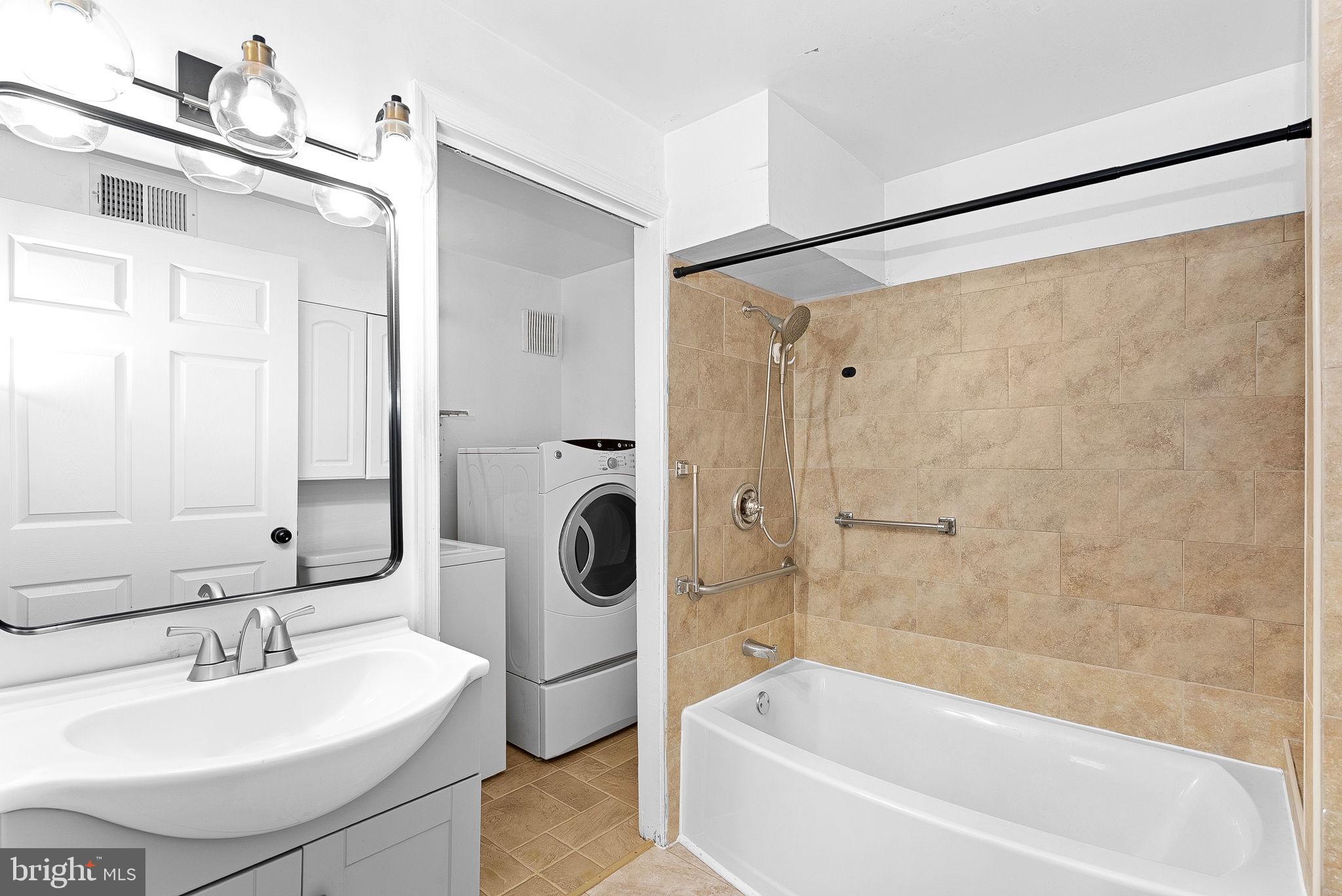 31 Main Street Round Hill, VA 20141 - Photo 15 of 35 a bathroom with a sink a mirror a shower and bathtub