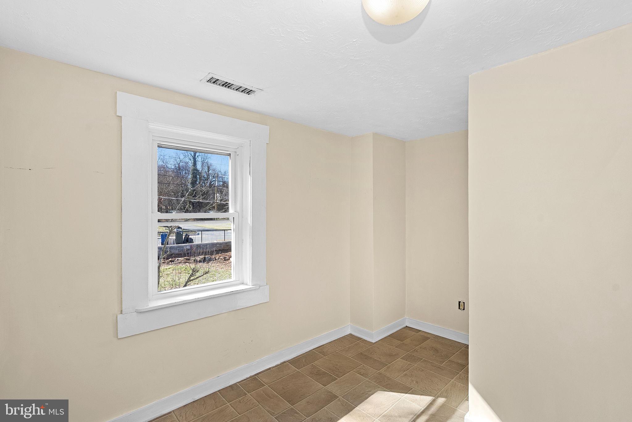 31 Main Street Round Hill, VA 20141 - Photo 18 of 35 a view of an empty room with wooden floor and a window