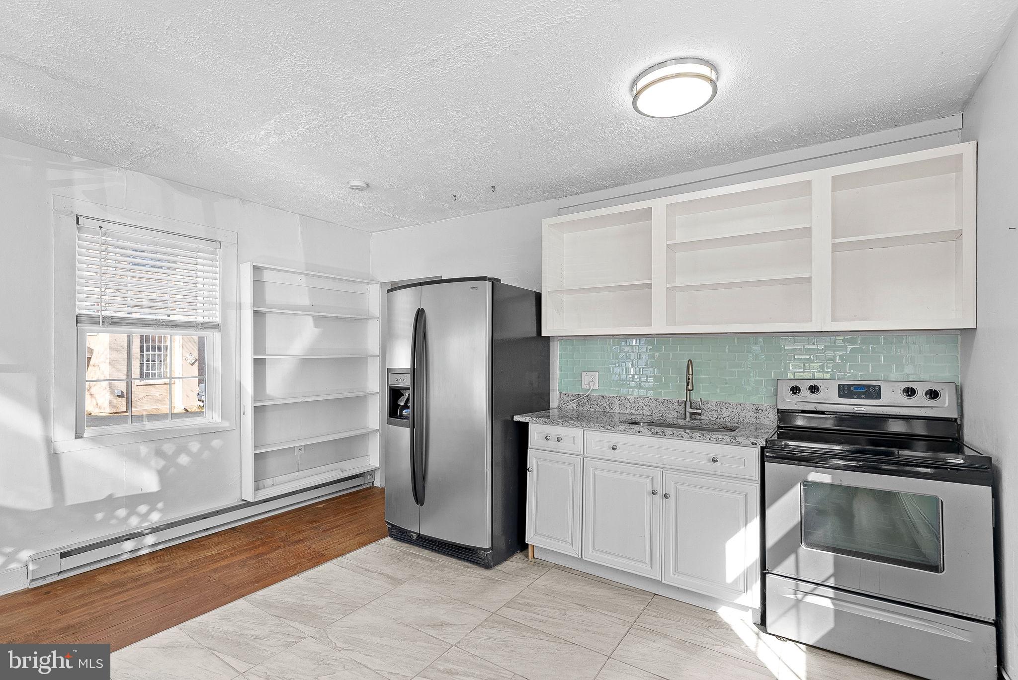 31 Main Street Round Hill, VA 20141 - Photo 25 of 35 a kitchen with a stove a sink and a refrigerator