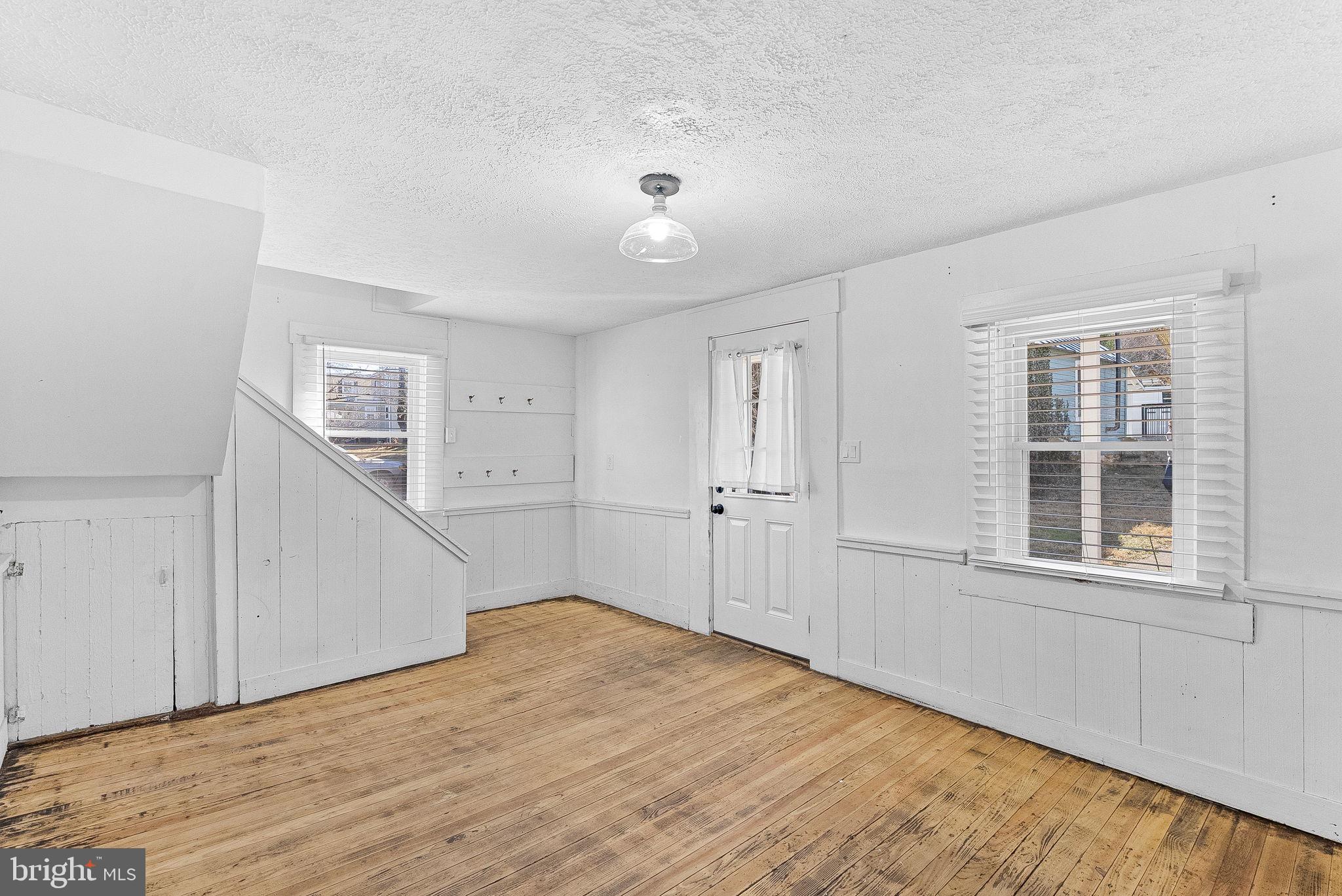 31 Main Street Round Hill, VA 20141 - Photo 6 of 35 a view of empty room with wooden floor and windows