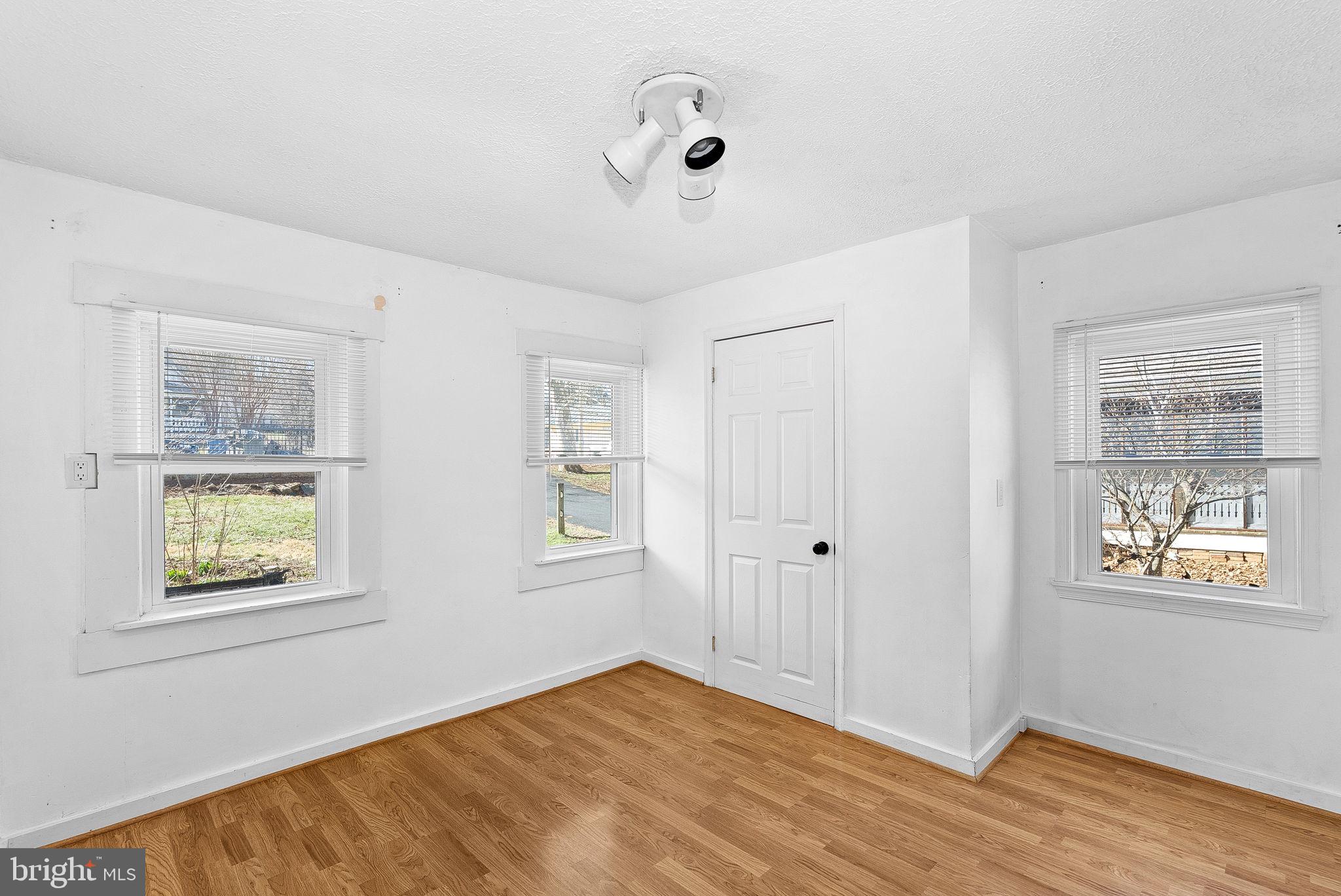 31 Main Street Round Hill, VA 20141 - Photo 7 of 35 a view of an empty room with window and wooden floor