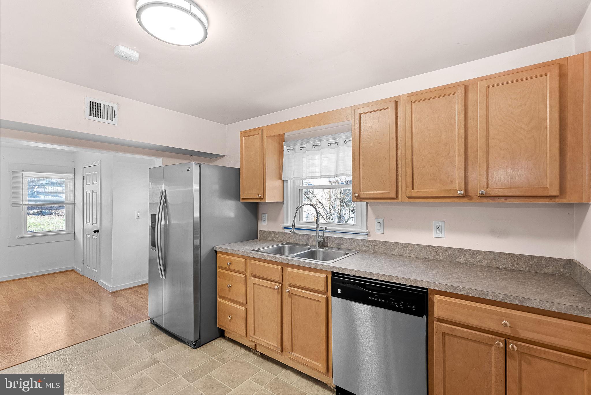 31 Main Street Round Hill, VA 20141 - Photo 9 of 35 a kitchen with stainless steel appliances granite countertop a refrigerator sink and cabinets