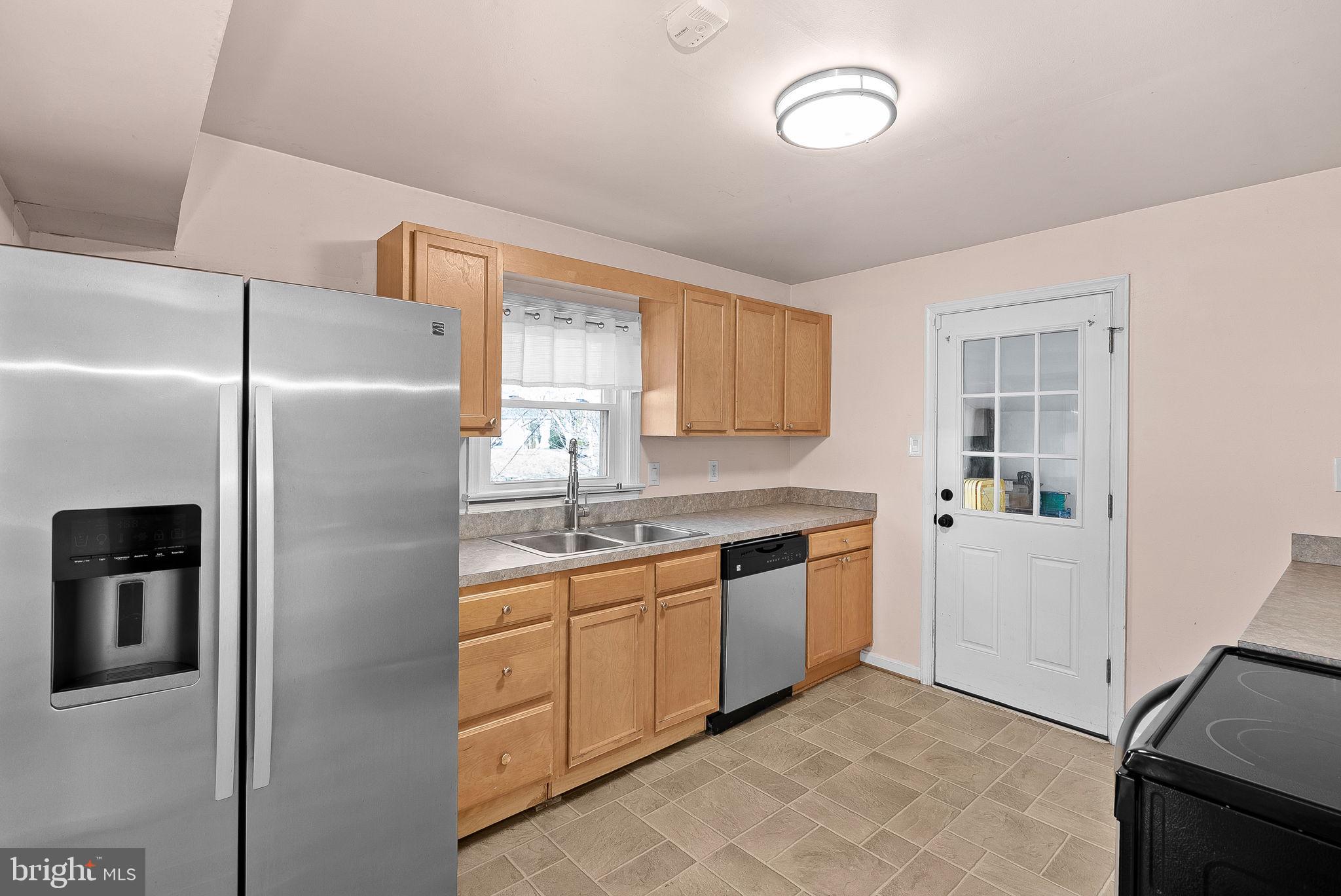 31 Main Street Round Hill, VA 20141 - Photo 10 of 35 a kitchen with stainless steel appliances granite countertop a refrigerator a sink a stove and island