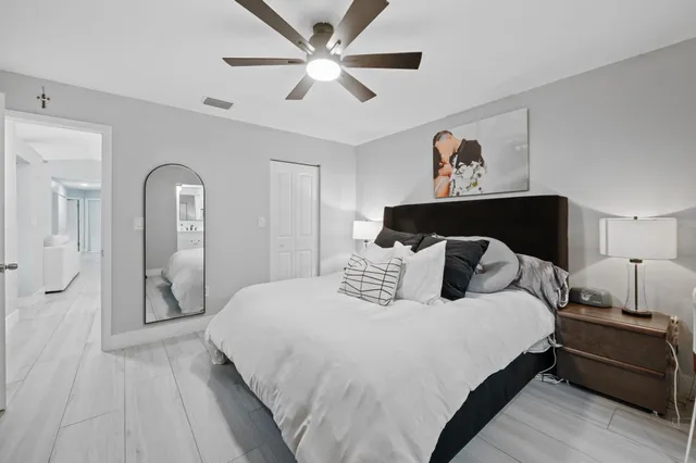 a bedroom with a large bed and a chandelier