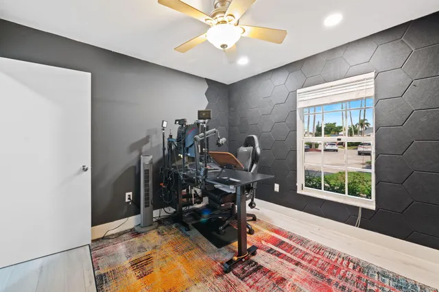a view of a workspace with furniture and a window