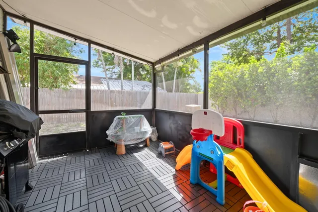 a living room with furniture and a floor to ceiling window