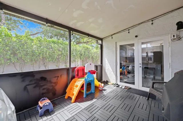 a living room filled with furniture and a floor to ceiling window