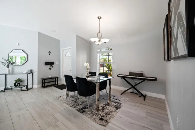 a living room with furniture a rug and a chandelier