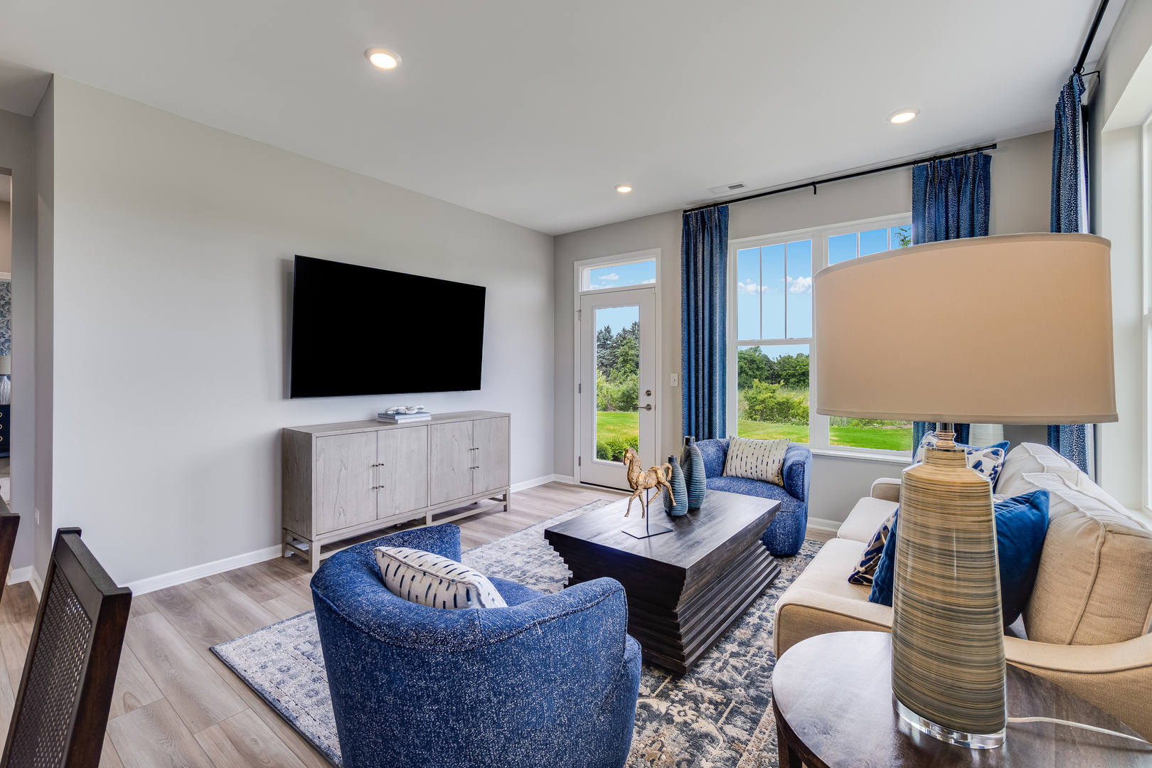 4245 Meadowridge Road Woodstock, IL 60098 - Photo 4 of 21 a living room with furniture and a flat screen tv