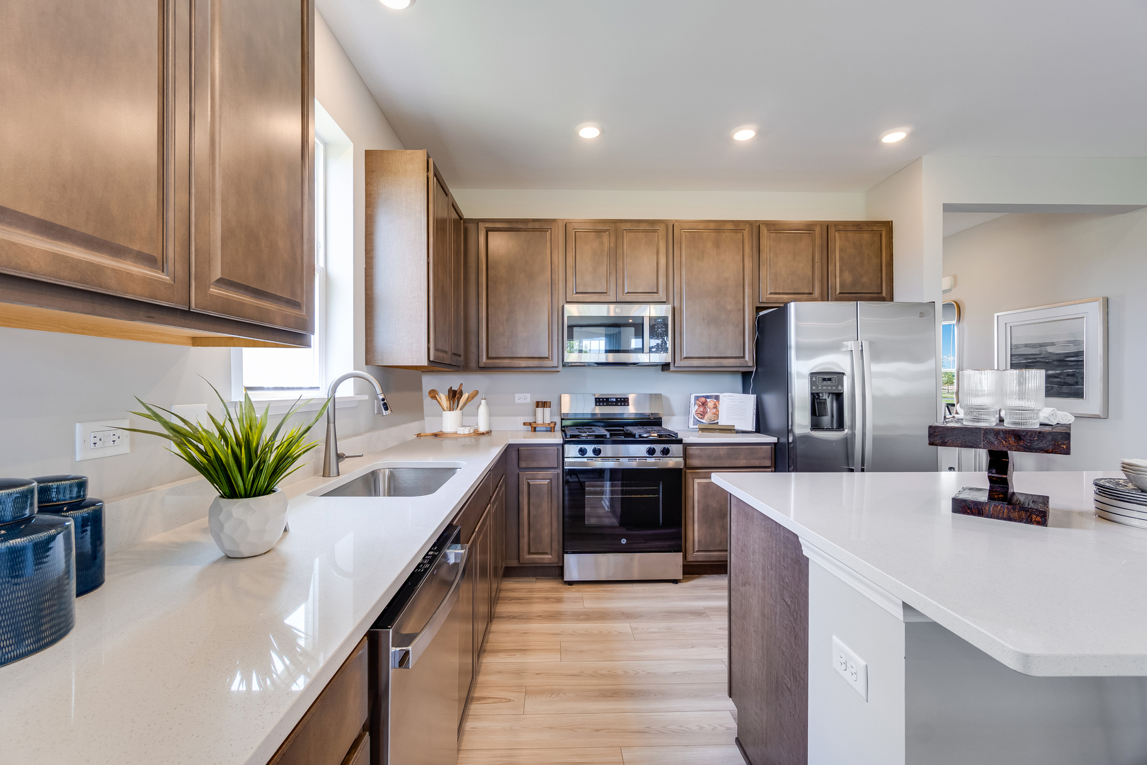 4245 Meadowridge Road Woodstock, IL 60098 - Photo 9 of 21 a kitchen with kitchen island granite countertop stainless steel appliances lots of counter space cabinets and a sink