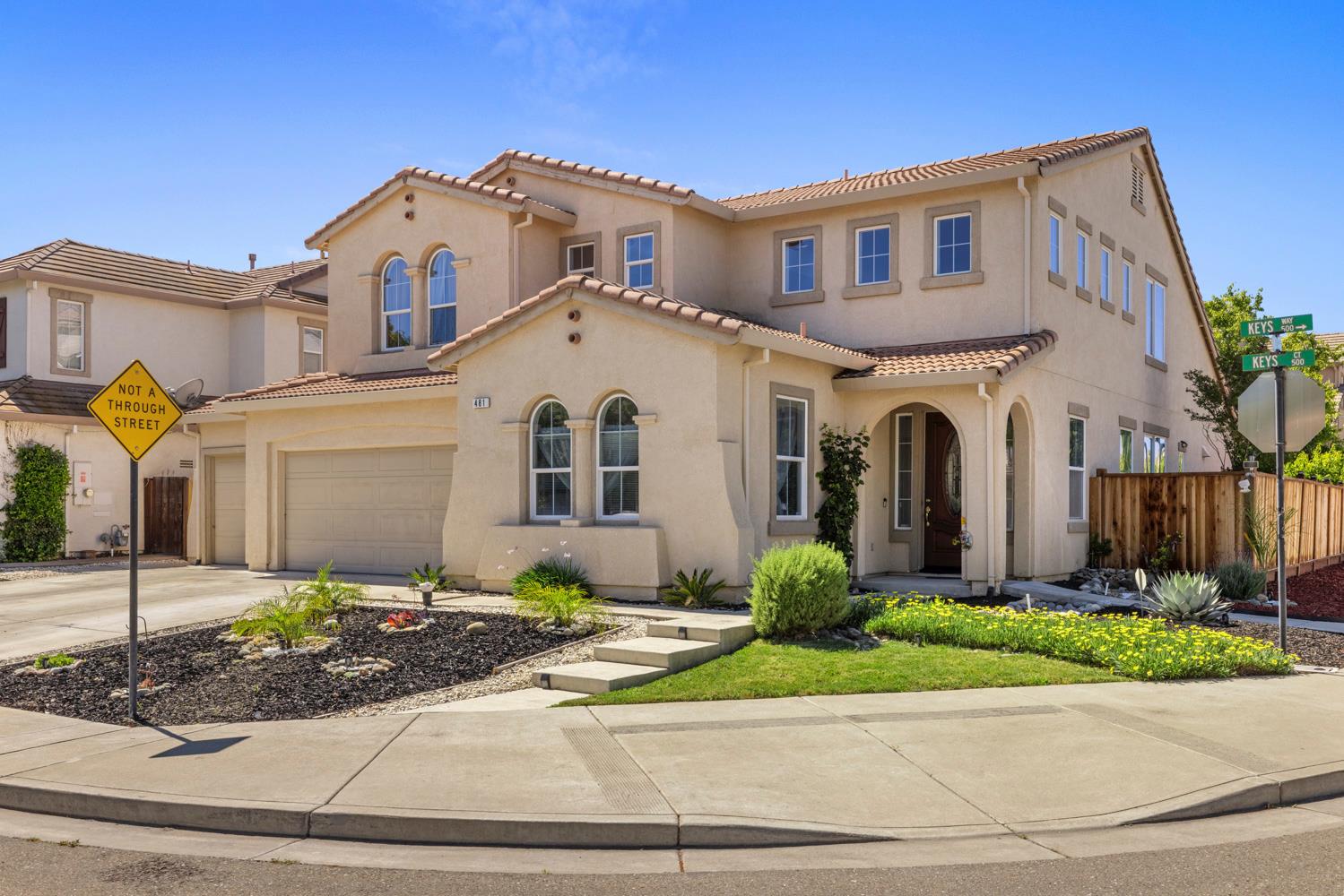 481 Keys Court Tracy, CA 95377 - Photo 1 of 45 a front view of a house with a yard and potted plants
