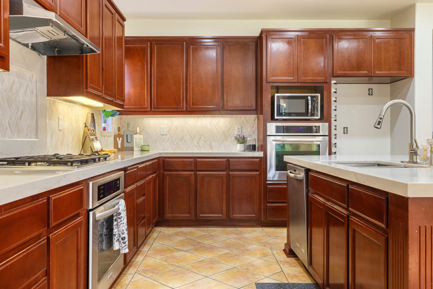 481 Keys Court Tracy, CA 95377 - Photo 11 of 45 a kitchen with stainless steel appliances granite countertop a sink stove and refrigerator