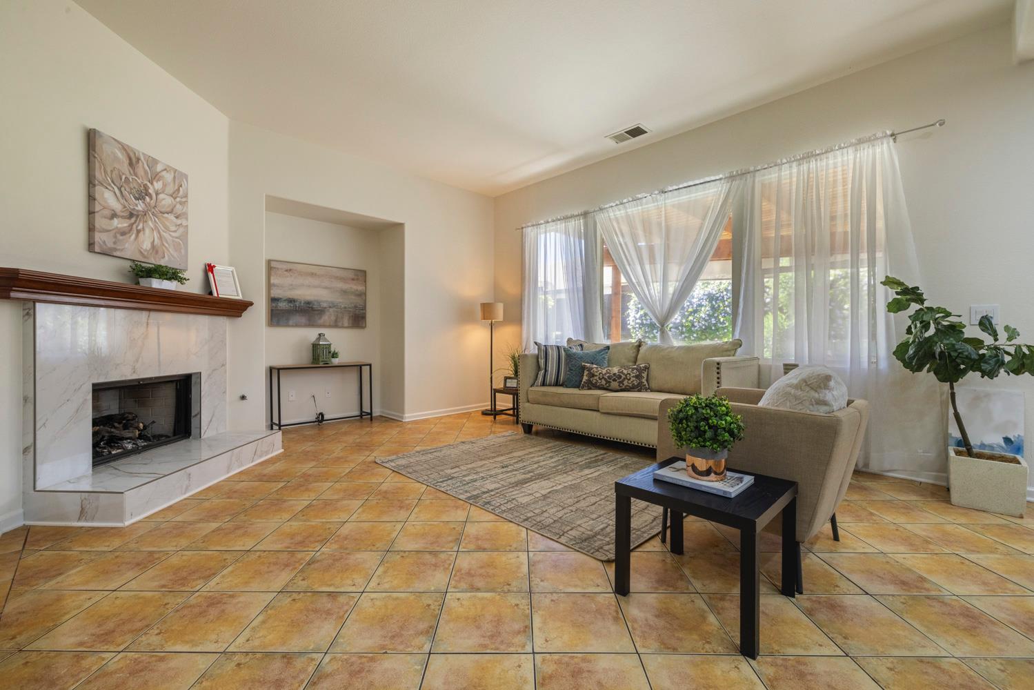 481 Keys Court Tracy, CA 95377 - Photo 12 of 45 a living room with furniture and a fireplace