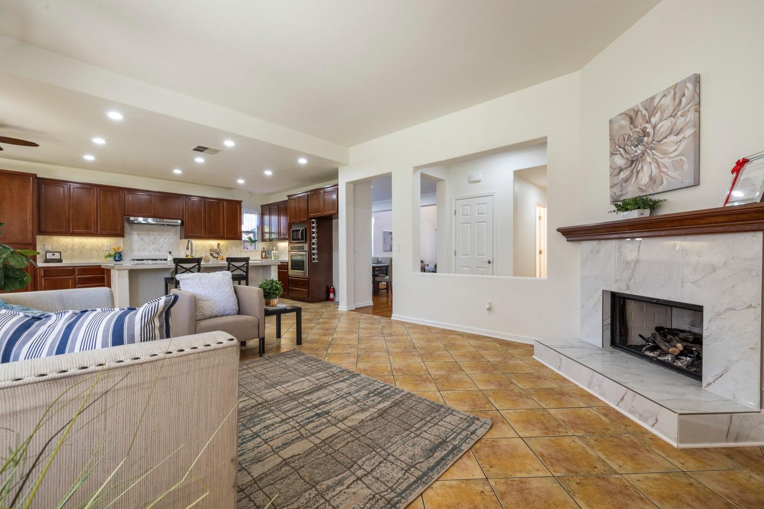 481 Keys Court Tracy, CA 95377 - Photo 13 of 45 a living room with furniture and a fireplace